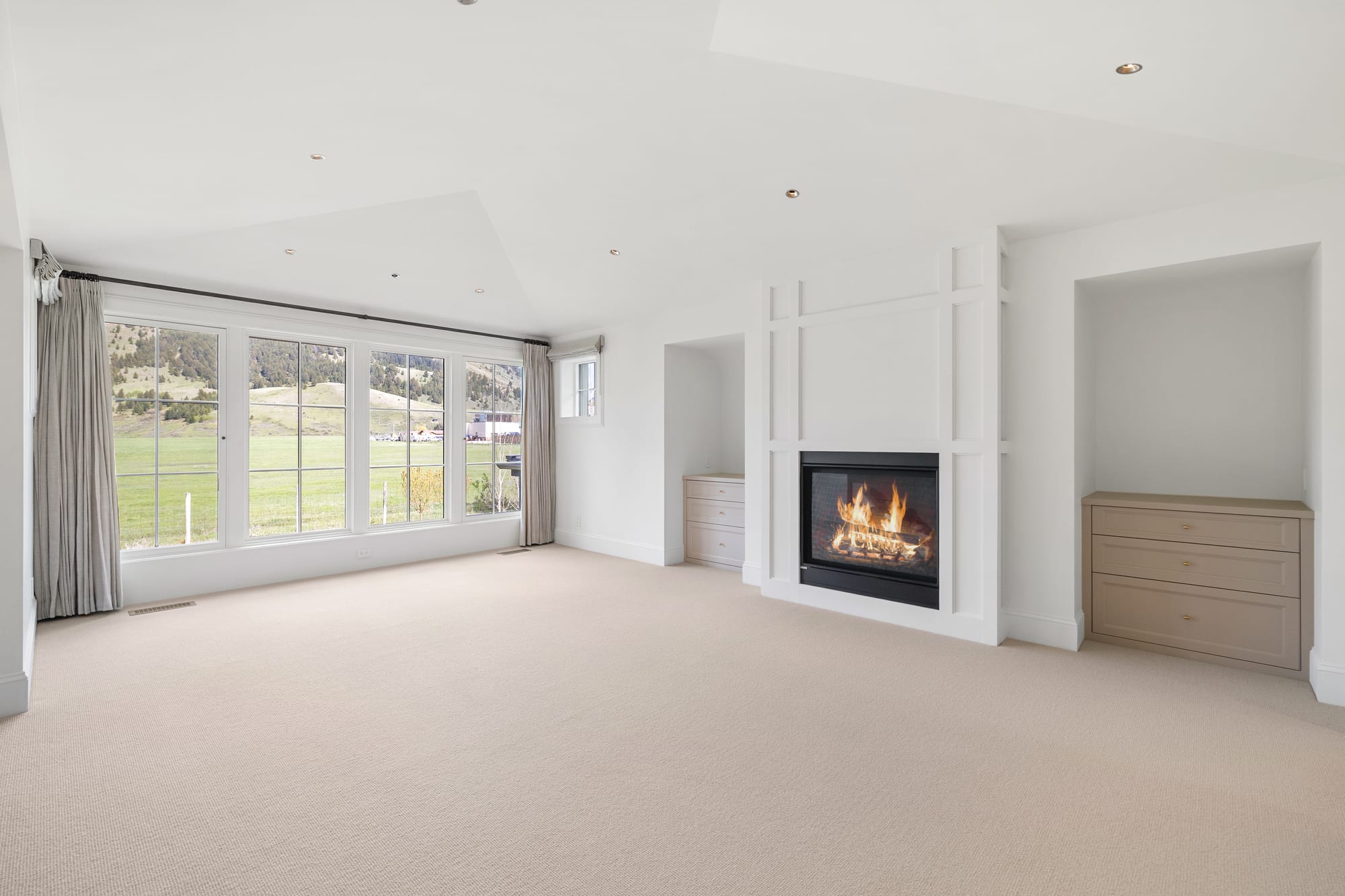 Primary bedroom with applied-moulding fireplace wall and built-in dresser niches.
