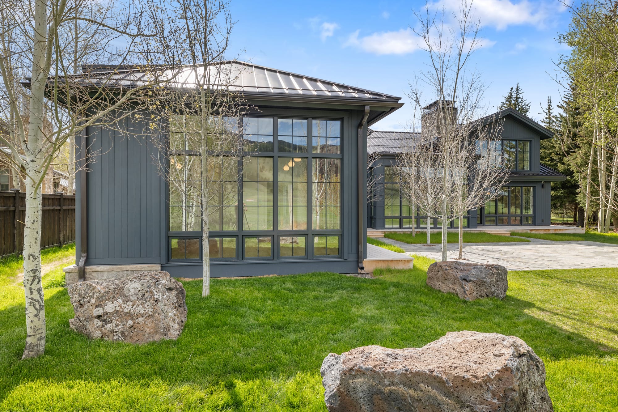 The studio pavilion — glass on three sides, set into the courtyard lawn.